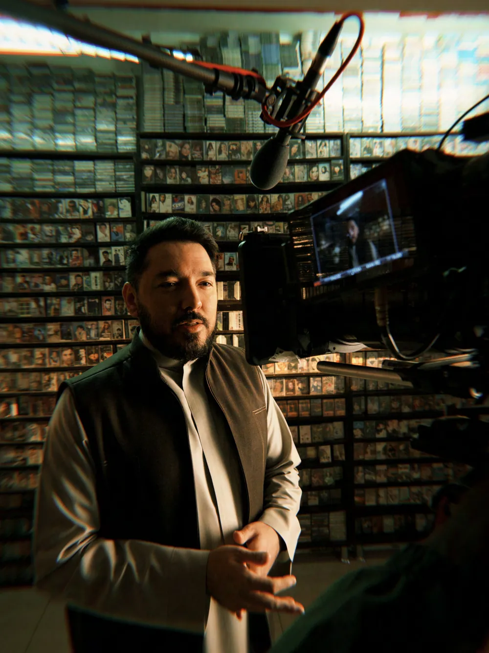 On set in an archive lined with shelves of tapes and boxes